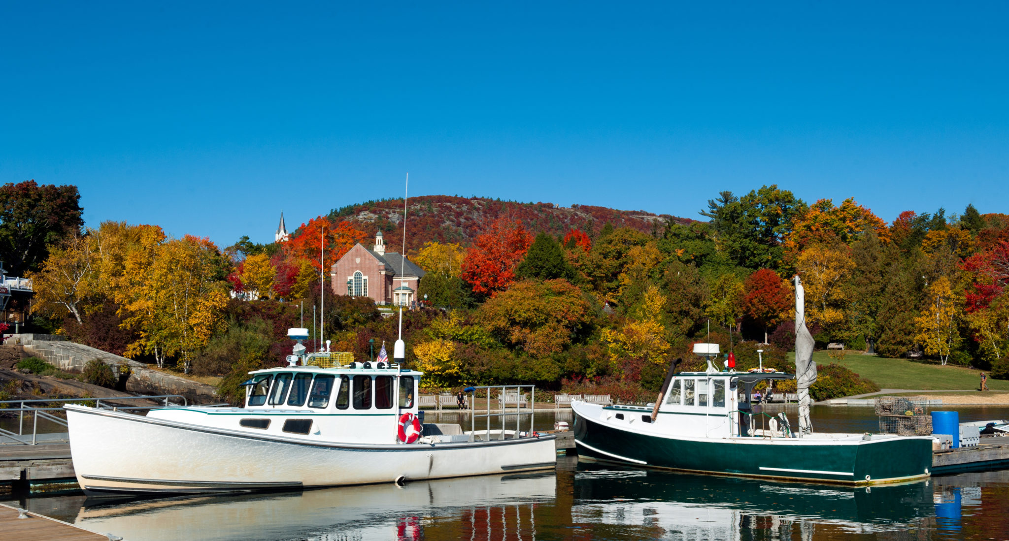 Lobster boats in Camden, Maine Harbor, fall foliage
