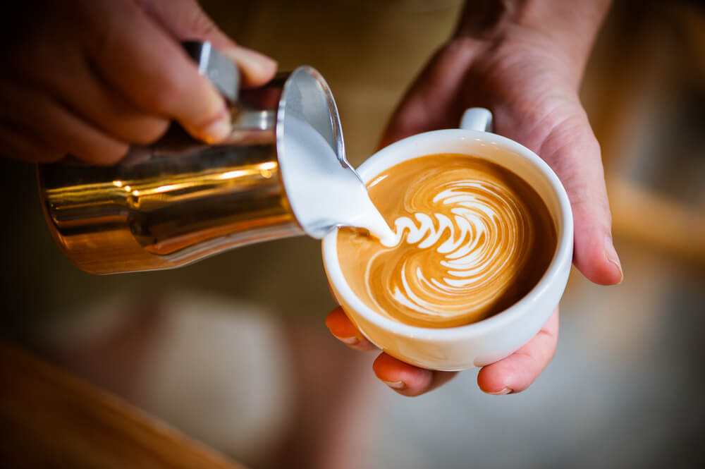 Photo of a Barista Pouring a Cup of Coffee in Camden, Maine.