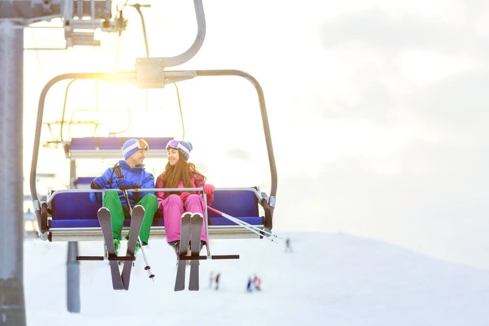 Photo of a Couple on a Ski Lift. Click Here for 15 Winter Date Ideas.