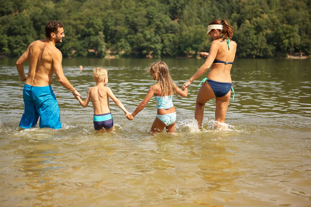 A family swimming a lake off of one of Camden, Maine Beaches